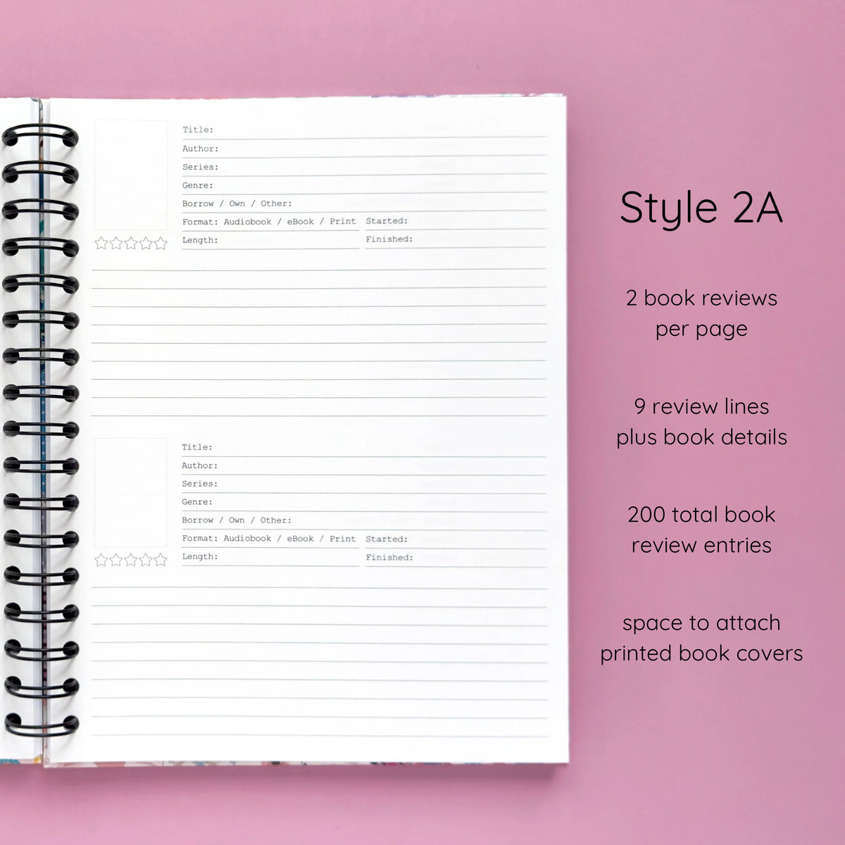 Open spiral-bound hardcover reading journal notebook showing review template option Style 2A featuring two book reviews per page and nine review lines plus book details per review with space to attach printed book covers, displayed on a lavender background