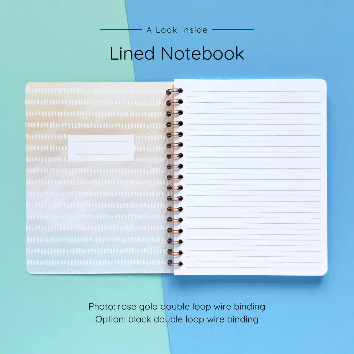 Open spiral-bound softcover lined notebook showing lined notes pages on a teal and blue background, featuring rose gold wire binding