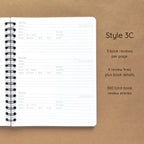 Open spiral-bound softcover reading journal notebook showing review template option Style 3C featuring three book reviews per page and four review lines plus book details per review, displayed on a brown background