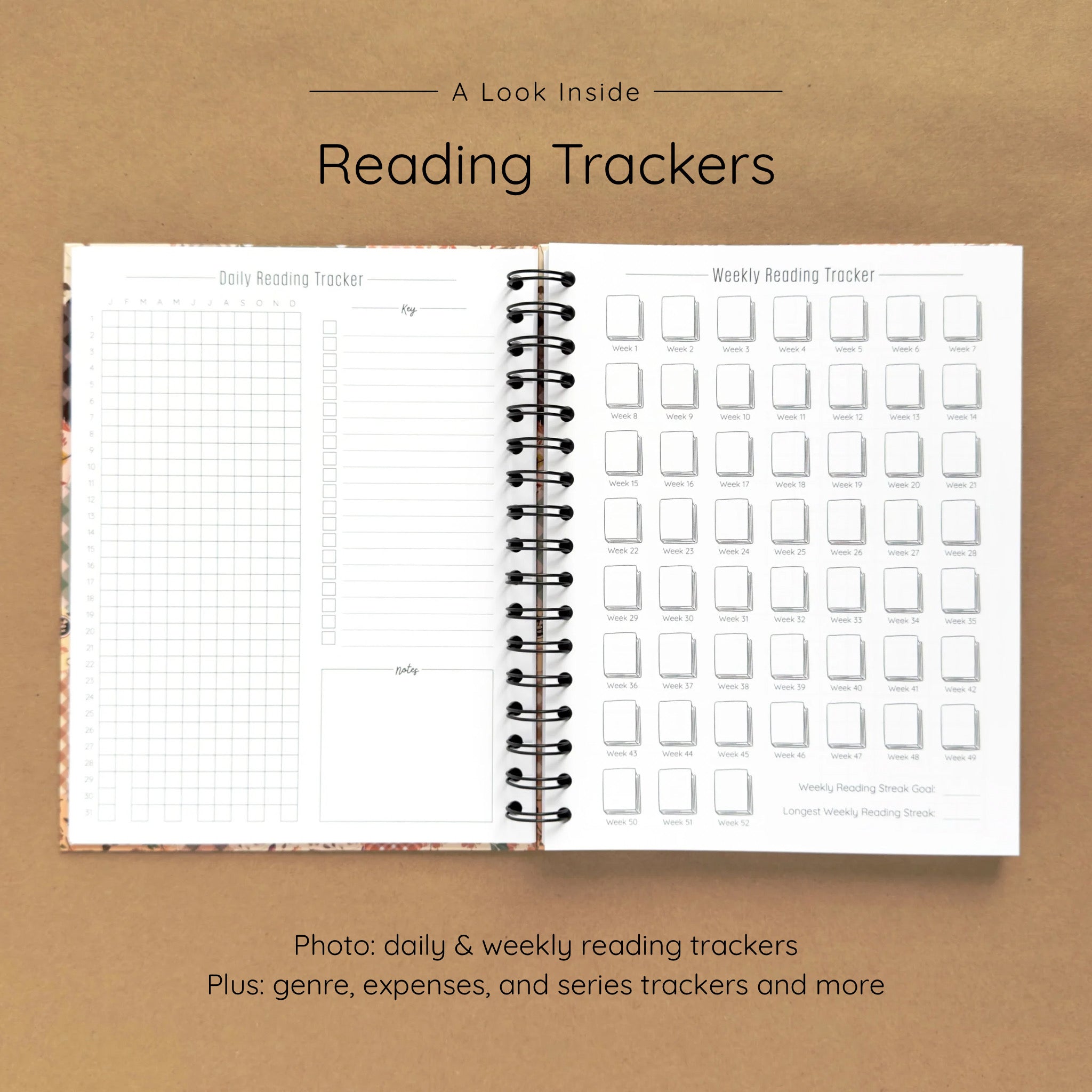 Open spiral-bound hardcover reading journal notebook showing daily and weekly reading trackers on a brown background