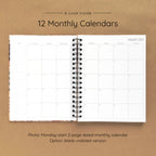 Open spiral-bound hardcover reading journal notebook showing monthly calendar pages on a brown background