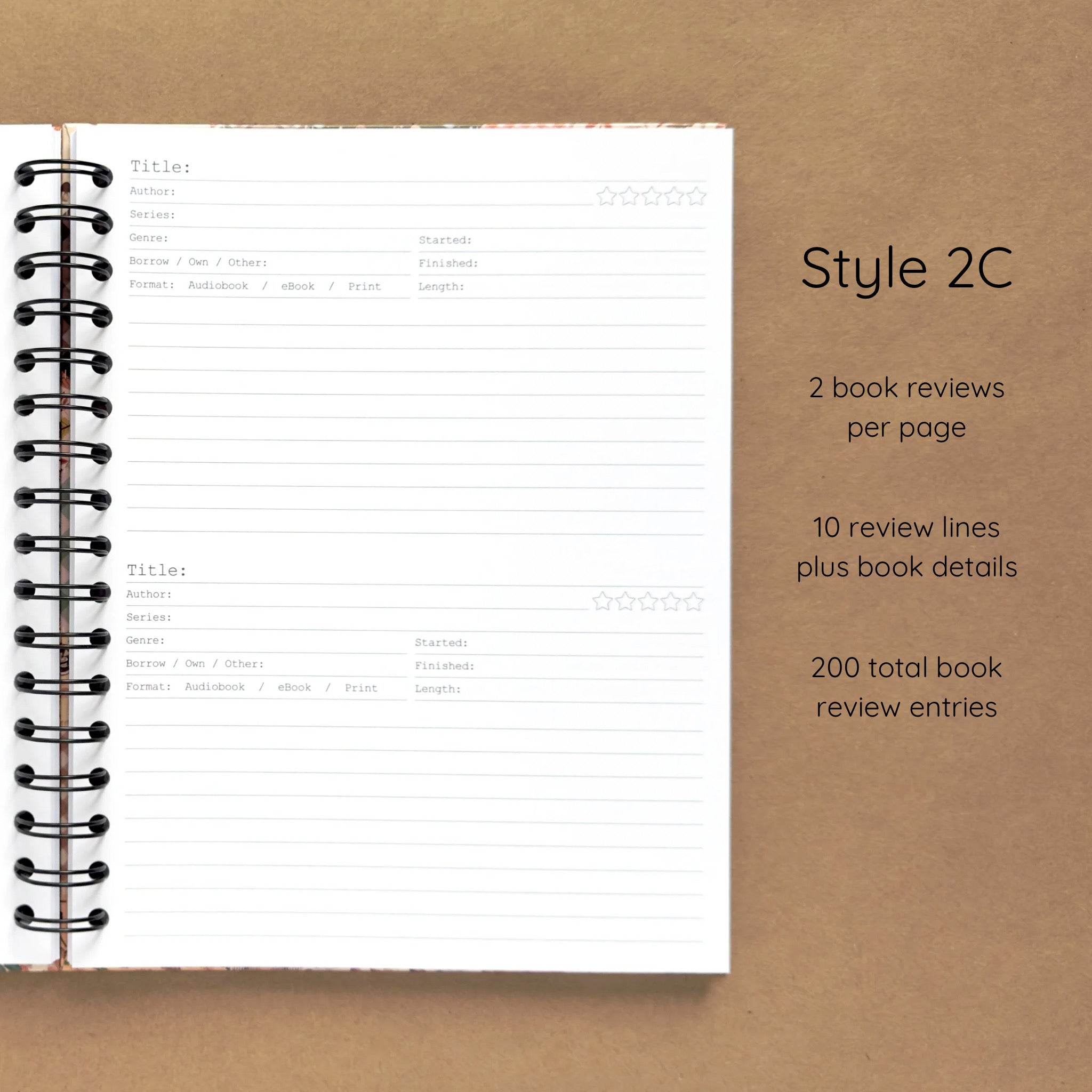 Open spiral-bound hardcover reading journal notebook showing review template option Style 2C featuring two book reviews per page and ten review lines plus book details per review, displayed on a brown background
