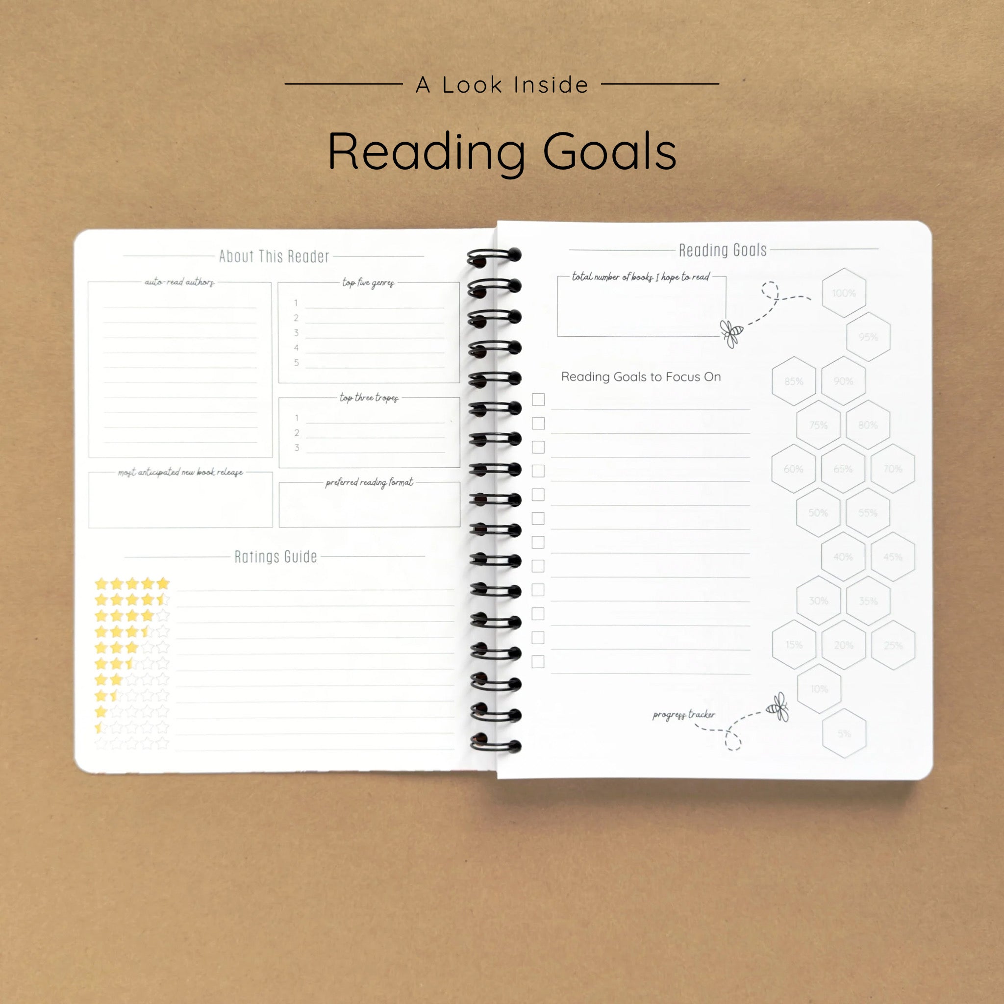 Open spiral-bound softcover reading journal notebook showing reading goals and ratings guide on a brown background