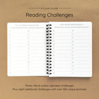 Open spiral-bound softcover reading journal notebook showing alphabet reading challenges on a brown background