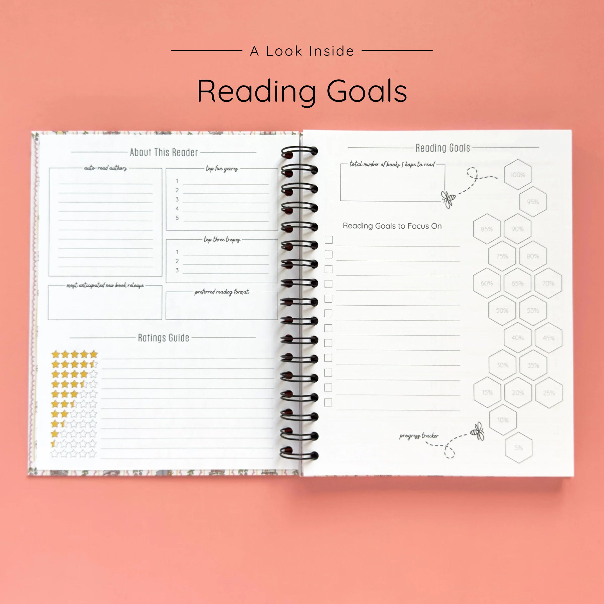 Open spiral-bound hardcover reading journal notebook showing reading goals and ratings guide on a peach background