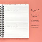 Open spiral-bound hardcover reading journal notebook showing review template option Style 2C featuring two book reviews per page and ten review lines plus book details per review, displayed on a peach background