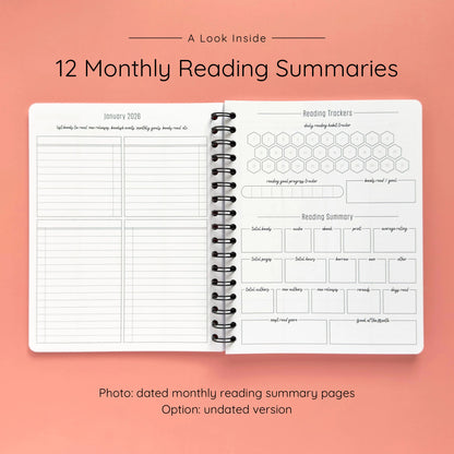 Open spiral-bound softcover reading journal notebook showing monthly reading summary pages on a peach background