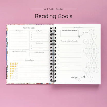 Open spiral-bound hardcover reading journal notebook showing reading goals and ratings guide on a lavender background