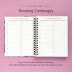 Open spiral-bound hardcover reading journal notebook showing alphabet reading challenges on a lavender background