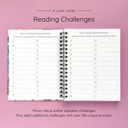 Open spiral-bound hardcover reading journal notebook showing alphabet reading challenges on a lavender background