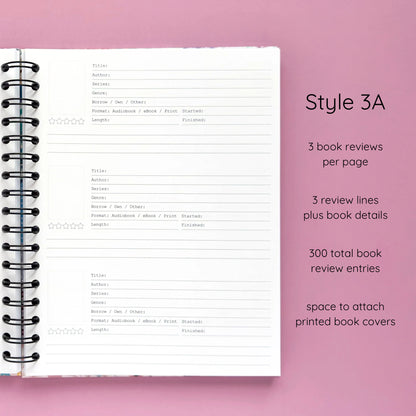 Open spiral-bound hardcover reading journal notebook showing review template option Style 3A featuring three book reviews per page and three review lines plus book details per review with space to attach printed book covers, displayed on a lavender background
