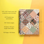 Spiral-bound hardcover lined notebook with autumn patchwork cover design on a yellow and orange background, featuring details and dimensions