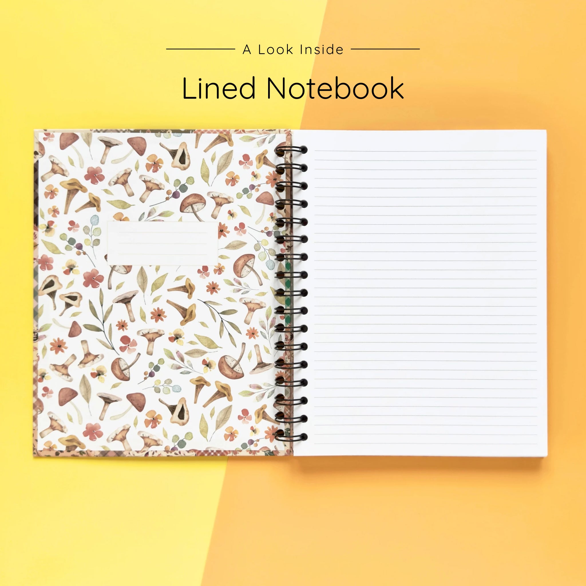 Open spiral-bound hardcover lined notebook showing lined notes pages on a yellow and orange background
