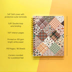 Spiral-bound softcover lined notebook with autumn patchwork cover design on a yellow and orange background, featuring details and dimensions