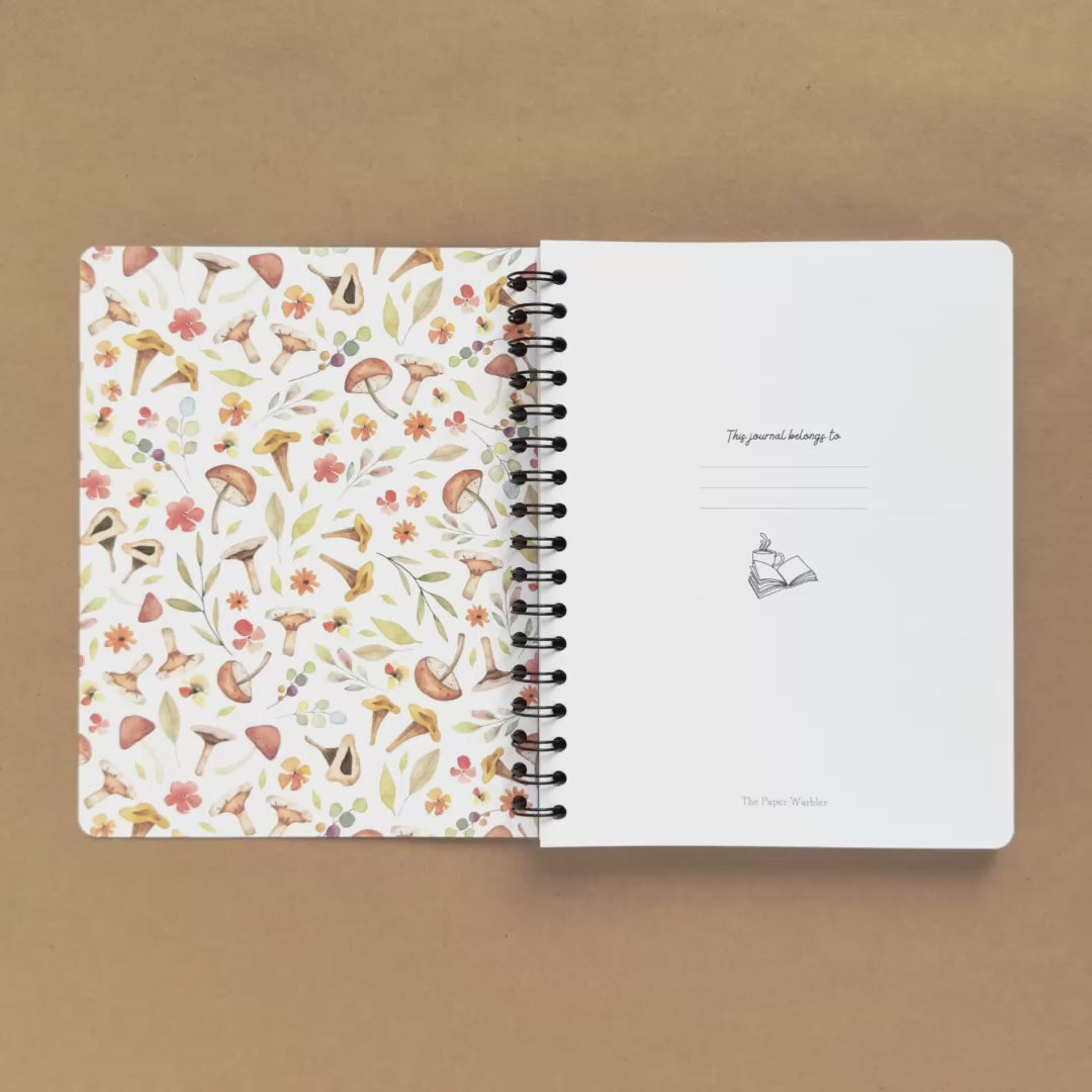 Spiral-bound softcover reading journal flip through video with autumn patchwork cover design on brown background