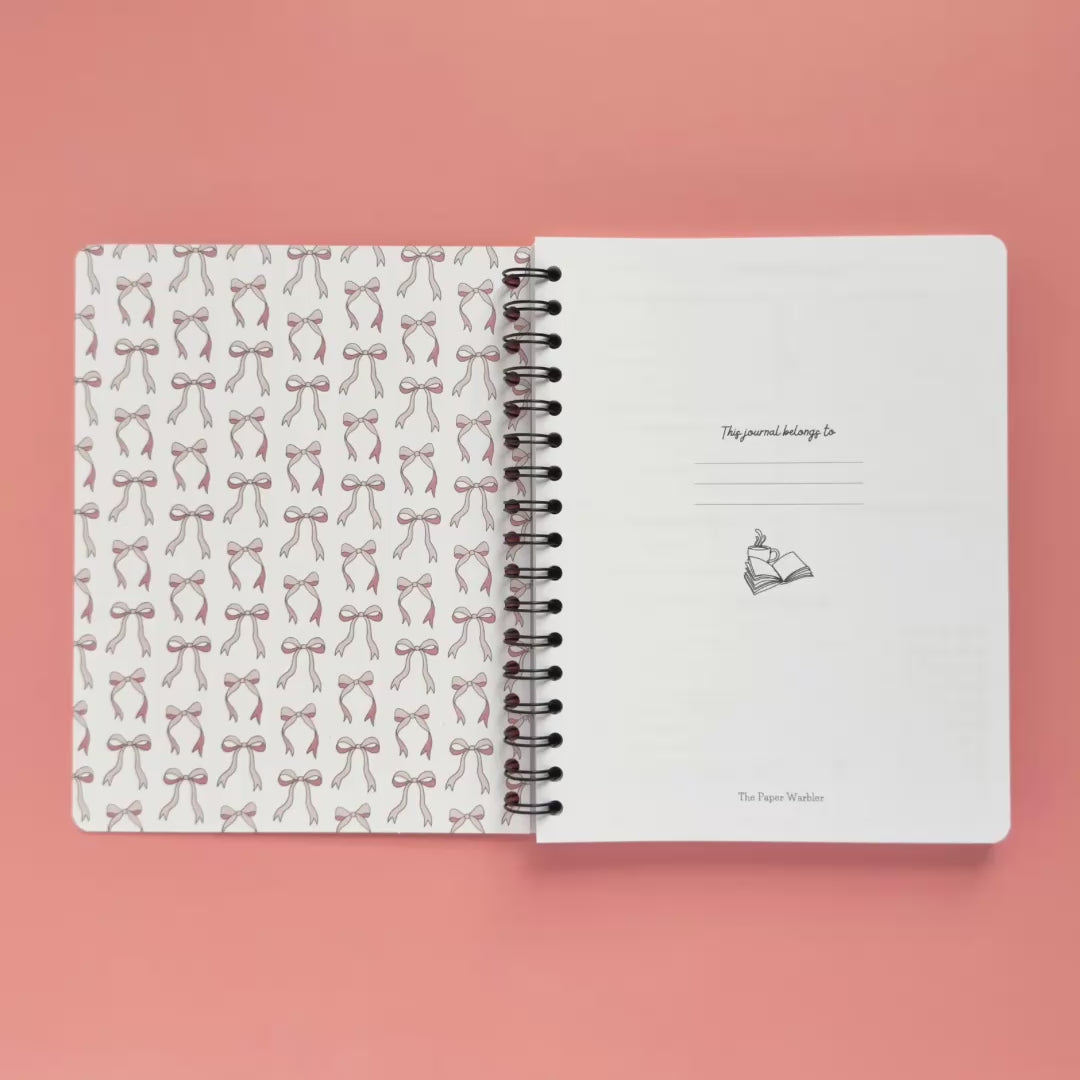 Spiral-bound softcover reading journal flip through video with books and bows coquette cover design on peach background