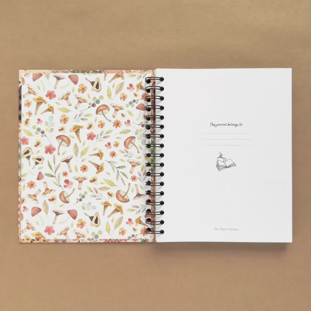 Spiral-bound hardcover reading journal flip through video with autumn patchwork cover design on brown background