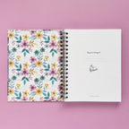 Spiral-bound hardcover reading journal flip through video with floral patchwork cover design on lavender background