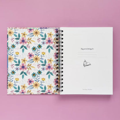 Spiral-bound hardcover reading journal flip through video with floral patchwork cover design on lavender background
