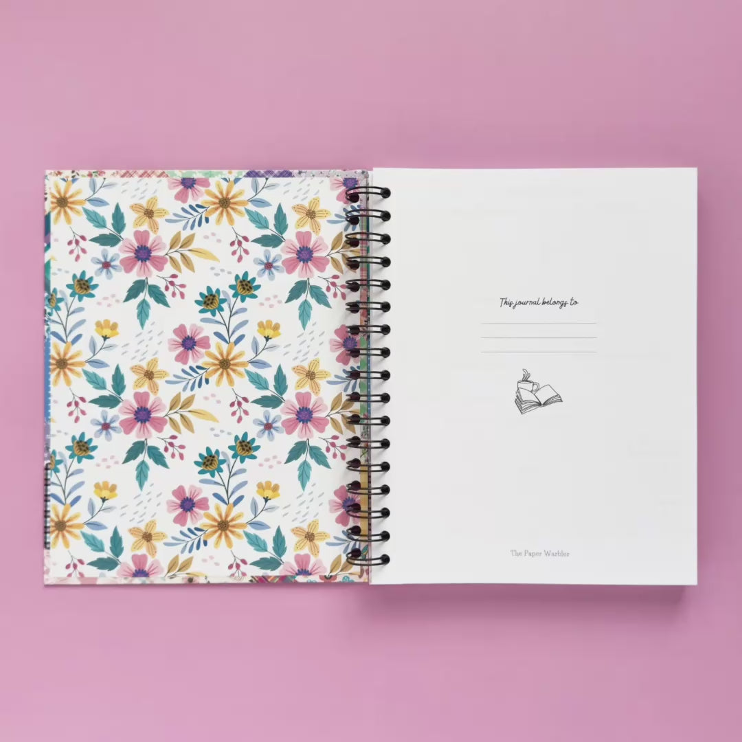 Spiral-bound hardcover reading journal flip through video with floral patchwork cover design on lavender background